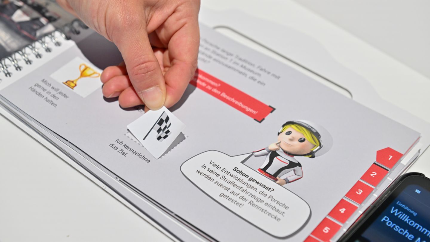 The kids can jot down the correct answers in their activity book, 2023, Porsche AG
